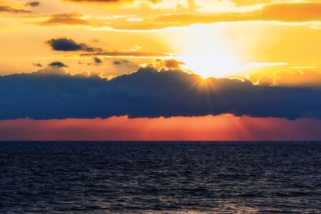 Magnificent multicolored sunset on the sea in the eveningの写真素材
