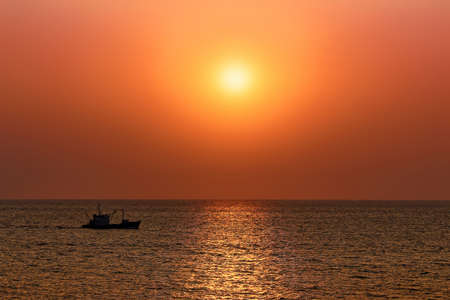 A magical bright orange sunset over the seaの写真素材