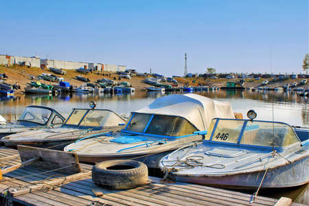 Many boats and launchs are moored at the boat stationの写真素材