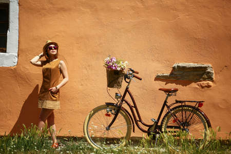 Young pretty woman outdoor fashion portrait. Beautiful girl in sunglasses enjoying the sun on the streetの写真素材