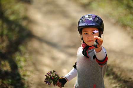 Portrait of hispanic girl with deep blue eyes in sunny parkの写真素材