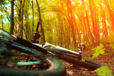 Beautiful scene of bike on sunset in mountains with deep cloudsの写真素材