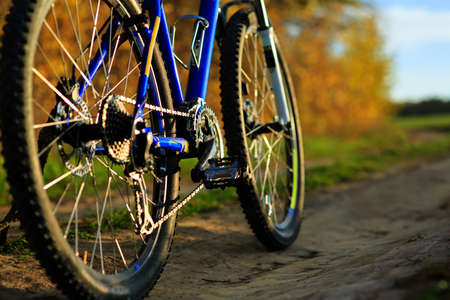 Beautiful close up scene of bicycle at sunset, silhouette of bike forward to sun, wonderful rural...
