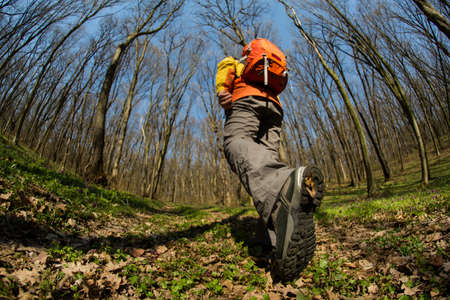 Hiker - man hiking in forest. Male hiker looking to the side walking in forest. Caucasian male model...