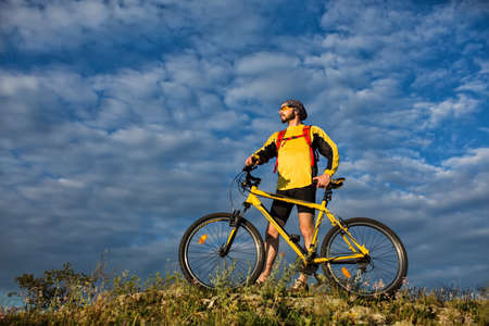 Cyclist Riding the Bike on the Trail in mountainsの写真素材