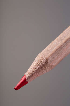 red pencil on gray backgroundの写真素材