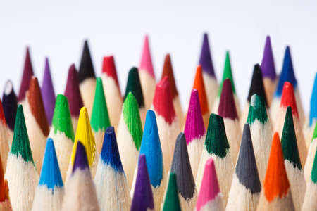 Color pencils of various color on a light background. Tips of the pencils. Standing. Craetive idea....