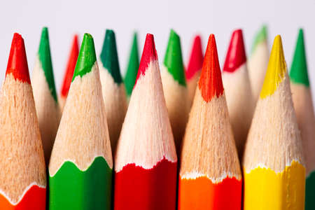 Color pencils of various color on a light background. Tips of the pencils. Standing. Craetive idea. Art and design. Painting and drawing. School and education.の写真素材