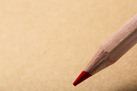 Brown notebook, top view. Wooden red pencil writing on tne brown paper.の写真素材