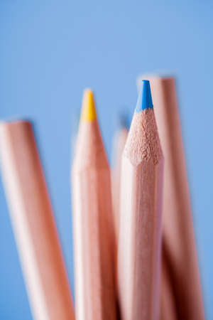 Macro view of crayons. Colored Pencils. Colored pencils on the blue background.の写真素材
