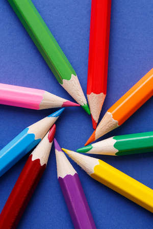 wooden colored pencils, on blue background, creative concept. Group of pencils. School and...