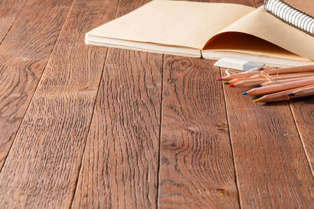 Noteboks and colorful pencils on the wooden table, eraserの写真素材