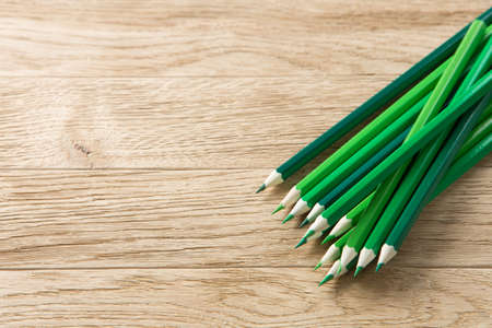 Drawing green pencils on a wooden backgroundの写真素材