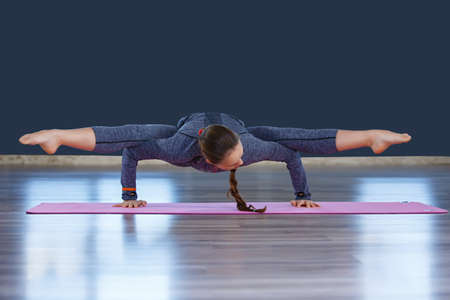 Young slim woman in yoga hole making beautiful asana exercises. Healthy lifestyle in fitness club....