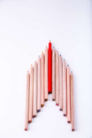 the wooden pencil arrange as head of arrow with one different as a symbol of difference concept. Eye-catching red pencil among identical wooden pencils. Concept about individual. Art and design. Artist.の写真素材
