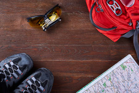 Top view of the set of equipment for travelling on brown wooden boards.
