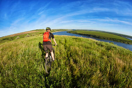 Active bicyclist at the riverside