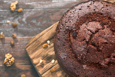 Sliced delicious chocolate cake with cutlery on wooden tableの写真素材