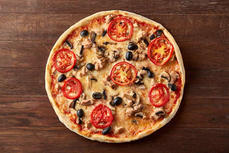 delicious italian pizza served on wooden tableの写真素材