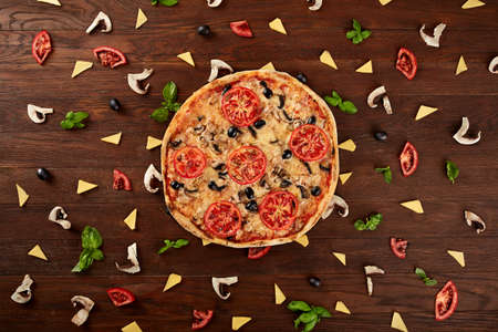 delicious italian pizza served on wooden tableの写真素材