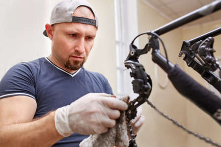 Bicycle mechanic in a workshop in the repair processの写真素材
