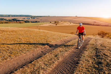 Traveler with backpack Riding the Bike on the Beautiful autumnの写真素材