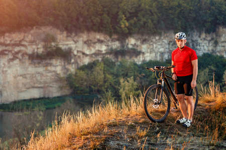 Traveler with backpack Riding the Bike on the Beautiful autumnの写真素材