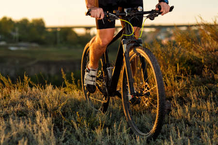 Bike adventure travel photo. Cyclist on the Beautiful Meadow Trail on sunny day.の写真素材