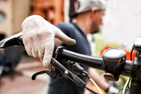Bicycle mechanic in a workshop in the repair processの写真素材