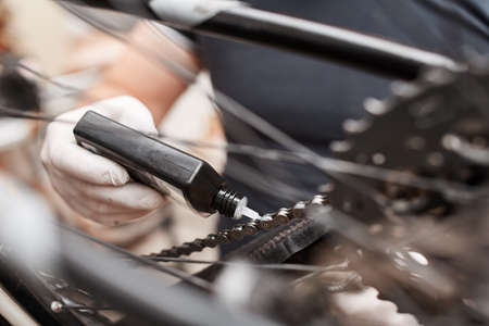 Cleaning and oiling a Bicycle chain and gear with oilの写真素材
