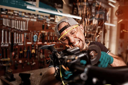 Crazy mechanic saws the bike by circular saw