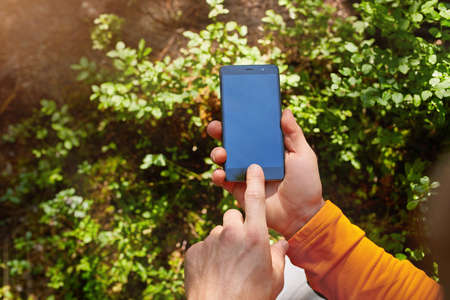 Business conceptual- Focused on left hand holding mobileの写真素材