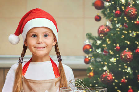 Little girl cooking Christmas biscuitsの写真素材