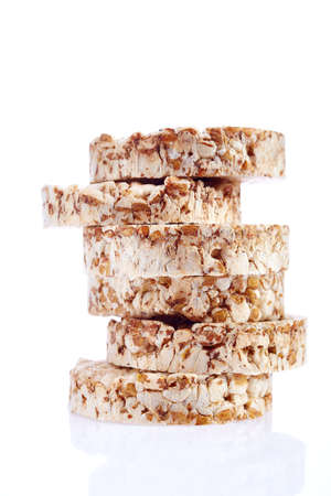 Round wheat crispbread, white background. Composition of grain crispbread on white background. Healthy and nutritious diet. Isolated on whiteの写真素材