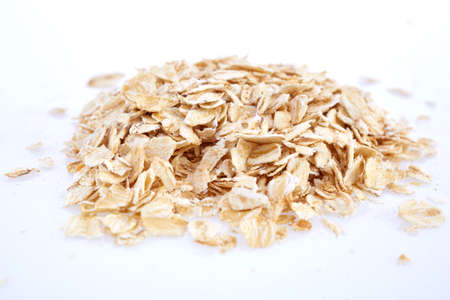 Oat flakes isolated on white background. Closeup viewの写真素材