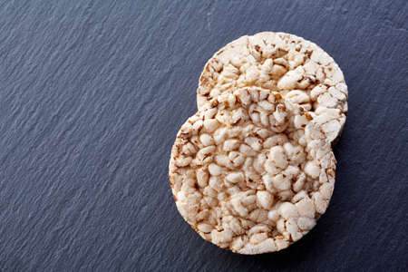 crispbread on stone plate. Dark stone background. Copyspace for text.