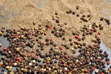 Spices on the stone black background. Condiments on a dark table.