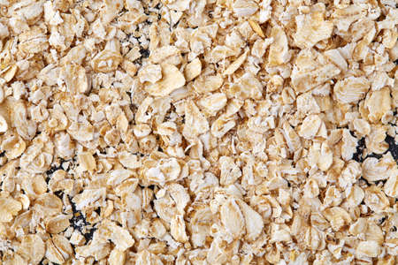 Yellow oats pyramid positioned in the corner on a black stone backgroundの写真素材
