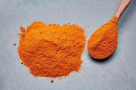 Shichimi pepper in Wooden spoon on black plate,