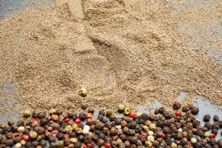 Mix of grind black pepper and black, white, red and yellow peppercorn. Selective focus.の写真素材