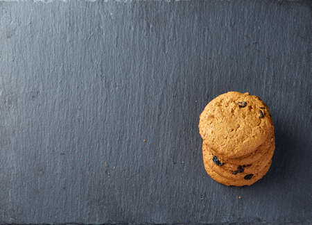 Close-up picture of chocolate cookies on dark background, shallow depth of field, lowkey. Extremely...