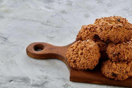 Top view close-up picture of tasty chocolate cookies on the cutting board, shallow depth of field,...