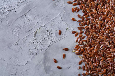 Top view close-up picture of separate flax seed on light textured background, macro, selective focus.の写真素材