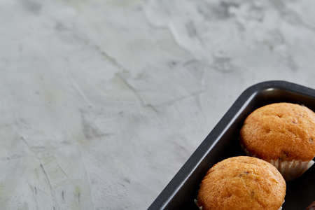 Fresh baked chocolate muffins on a cookie sheet, top view, close-up, selective focusの写真素材