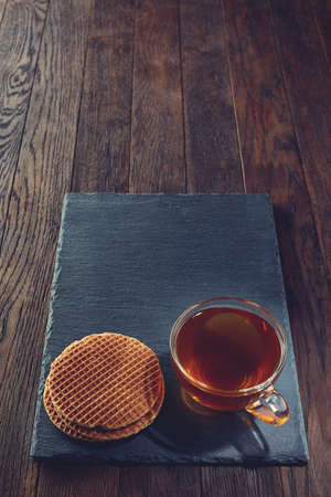 Cup of tea with meringues on a wooden background, top viewの写真素材