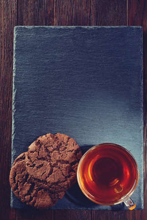 Cup of tea with meringues on a wooden background, top viewの写真素材