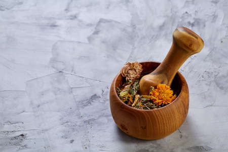 Spa still life with flowers in wooden bowl on light textured background, top view, close-up, selective focus. Alternative medicine. Spa natural concept. Dayspa cosmetics products. Spa and wellness setting. spa decoration conceptの写真素材