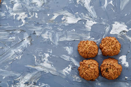 Sweet cookies with raisin arranged in pattern on light textured background, top view, close-up, shallow depth of field, selective focus. Yummy and crunchy dessert. Artistic conceprual pattern. Sweet decoration. Delicious snack. Breakfast background.の写真素材
