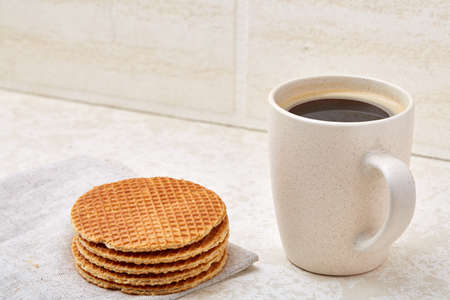 Top view closeup picture of tea in transparent cup with cookies and cotton napkin on white background, selective focusの写真素材