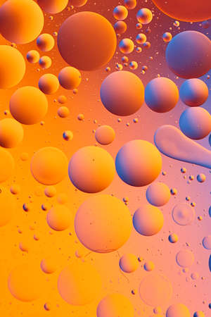 Mixing water and oil, beautiful color abstract background based on red and yellow circles and ovals, macro abstractionの写真素材